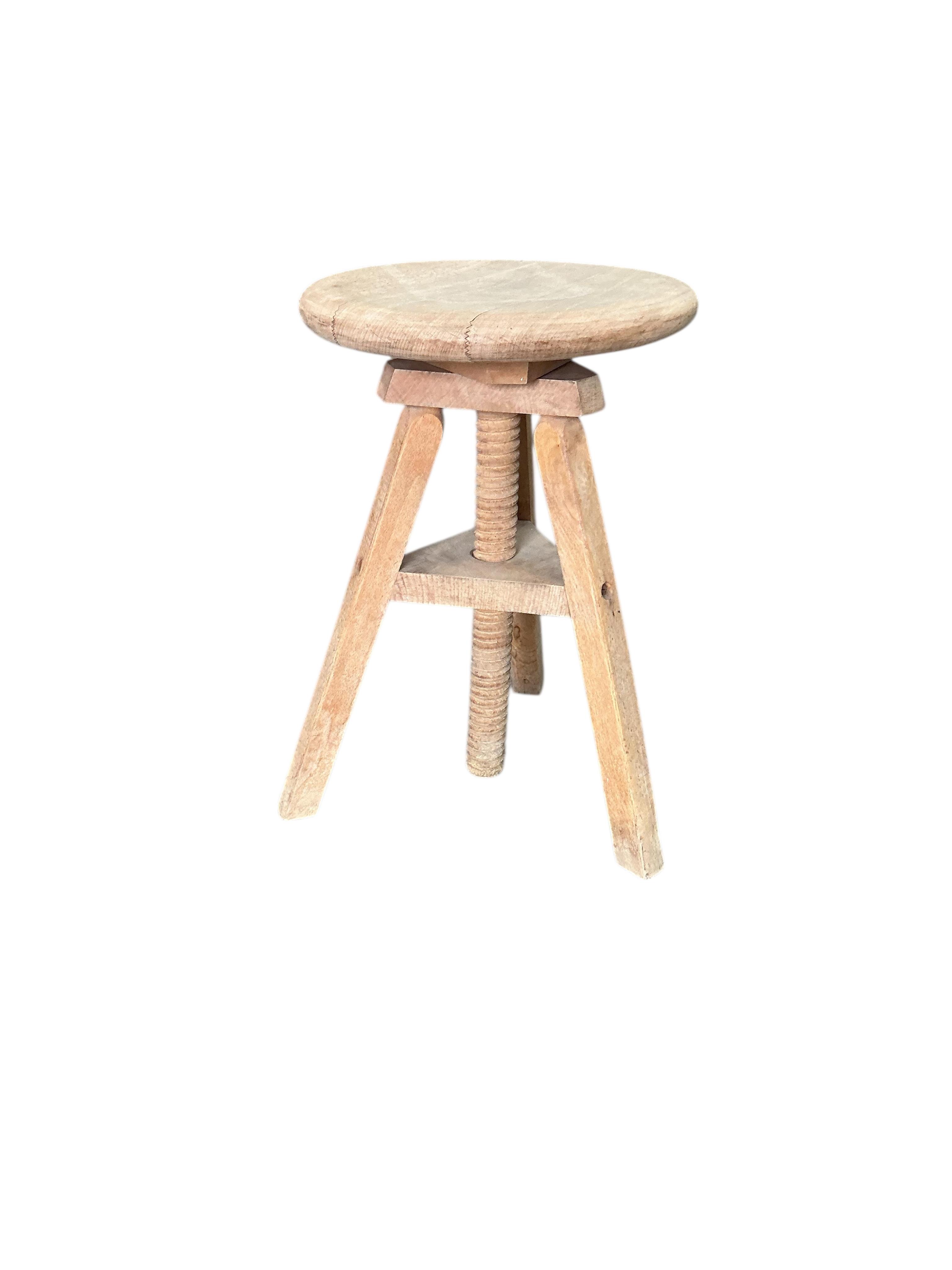 A circular beech revolving adjustable stool